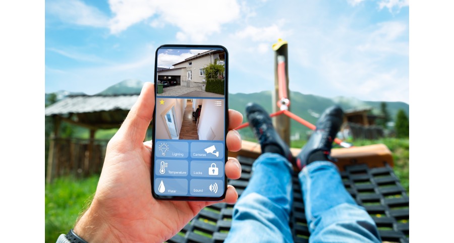 Man checking home security cameras while on vacation