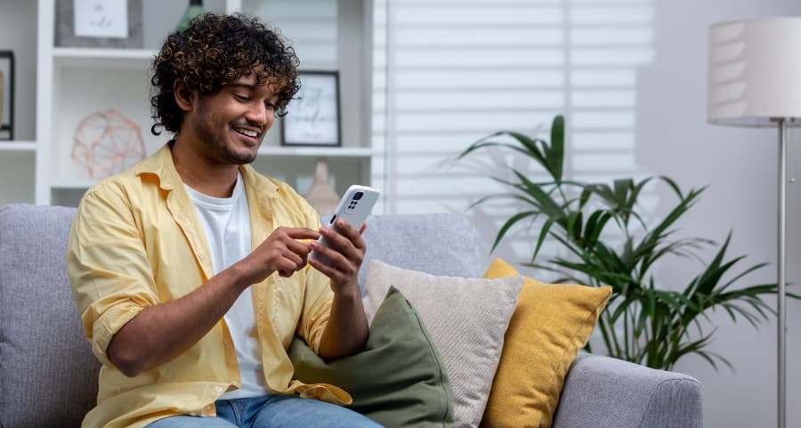 Resident navigating a home security app on his smartphone